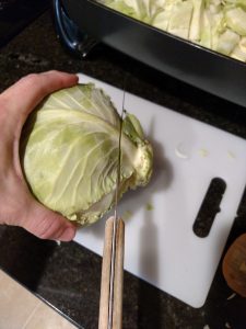 cutting bottom off of cabbage.