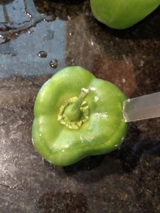 cutting top off of green pepper