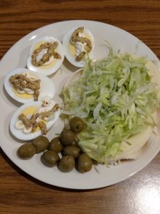 lazy deviled eggs, green olives and lunchmeat, cheese and shredded lettuce "sandwich"