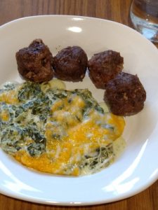 3 Ingredient Keto Crock Pot Meatballs and Creamy spinach cheese bake on white plate