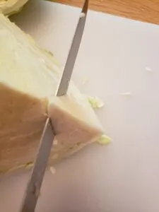 cutting the core out of a cabbage