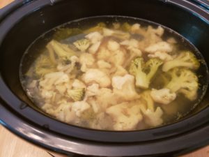broccoli and cauliflower in broth in crock pot after cooking