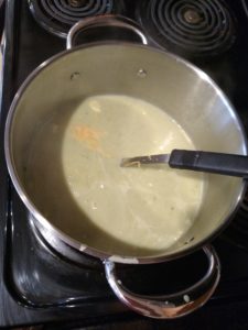 Creamy Broccoli Cauliflower Cheese Soup in pot on stove