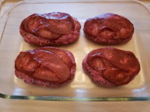 Paleo Meatloaf made into four small loaves and in glass baking dish