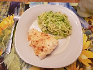 Crab Topped Fish and zucchini noodles parmesan on plate