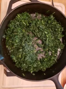 cooking spinach in butter in skillet