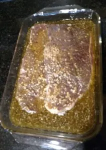 meat and marinade in glass baking dish