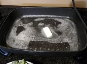 butter melting in a large electric skillet