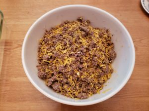 ground beef, onion soup mix and shredded cheese in mixing bowl.