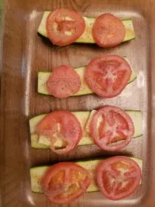 sliced tomato on zucchini