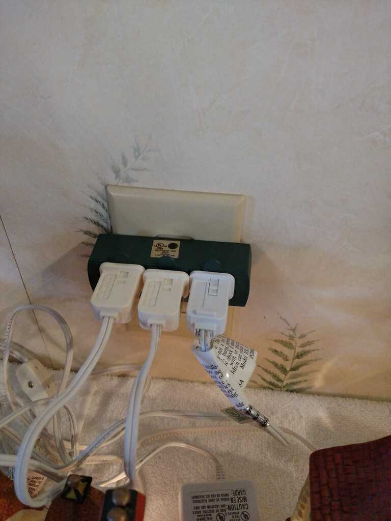 village lights plugged into wall with triple plug