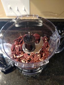 pecans in food processor ready to make into pecan meal