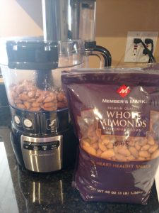 almonds next to and in food processor ready to make into pecan meal