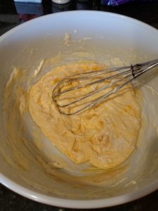 whisking cheeses together