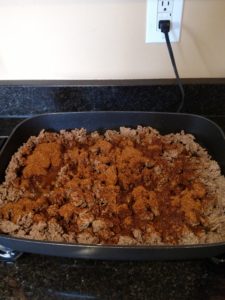 meat and Homemade Taco Seasoning cooking in skillet