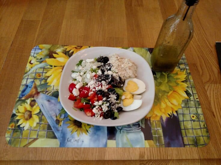 Homemade Italian Dressing Dry Mix on a salad pictured on a pretty sunflower mat