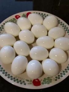 plate full of perfectly peeled hard boiled eggs