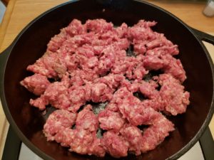 sausage cooking in a skillet