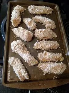 coconut crusted chicken on baking sheet