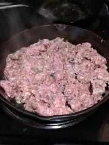 raw sausage in frying pan