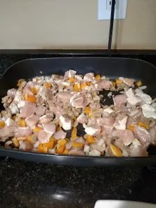 chicken and vegetables cooking in electric skillet