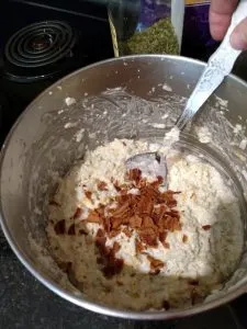 Twice Baked Cauliflower Casserole ingredients being mixed in a bowl