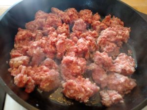 sausage cooking in skillet