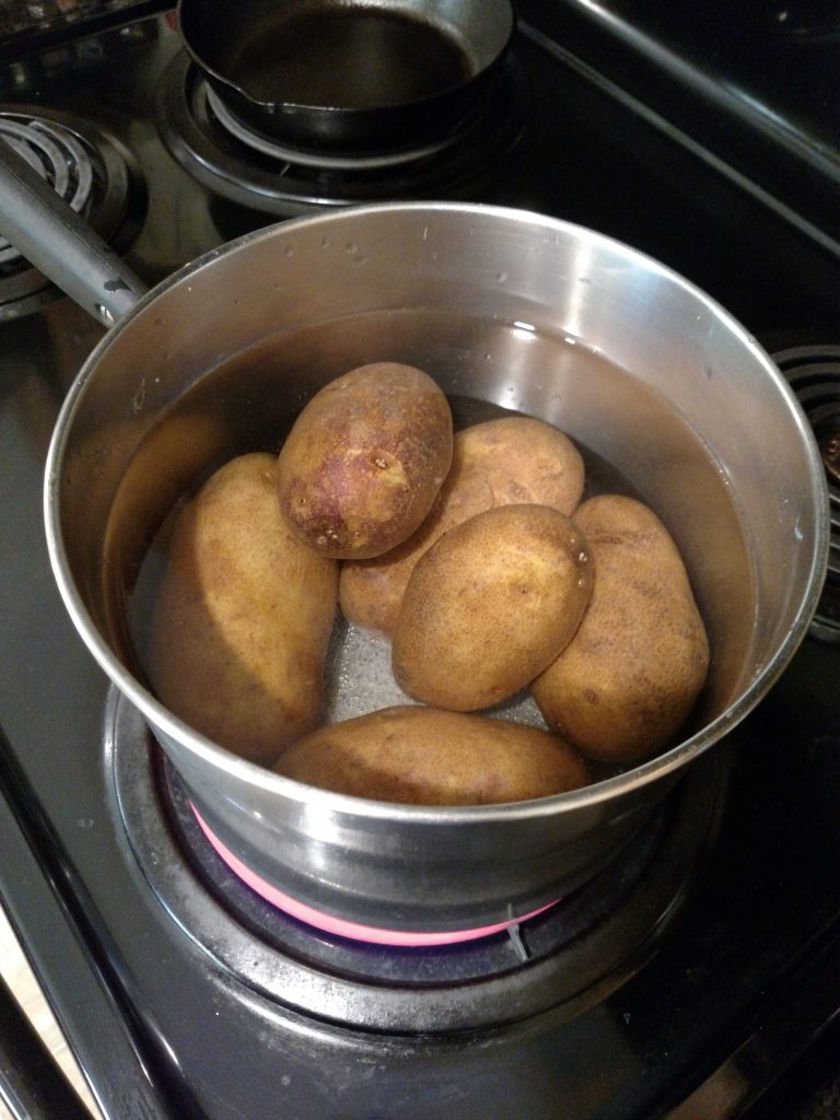 potatoes in water in pan on stovetop