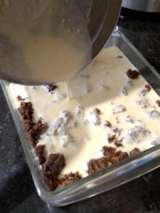 pouring cream and egg mixture over meat