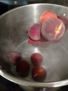 dunking peaches into boiling water.