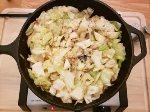 cooking cabbage and onion in skillet