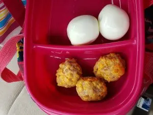 3 Low Carb Gluten Free Sausage Balls and 2 hard boiled eggs in to-go container