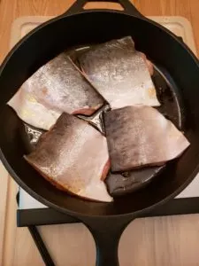 Blackened Salmon raw in skillet