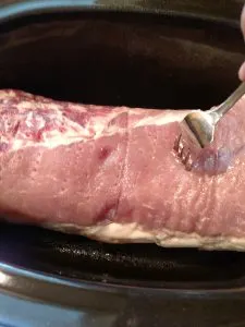 poking holes in the roast with a fork