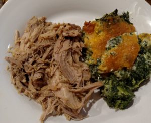 Easy Tender Pulled Pork and creamy spinach cheese bake on plate