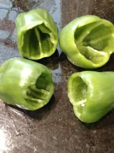 4 green peppers with tops cut off