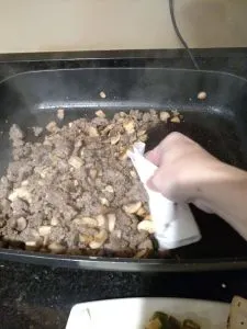 using paper towels to dab up grease in skillet