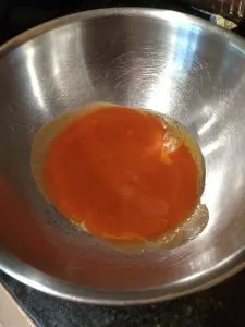 butter and Frank's hot sauce in mixing bowl