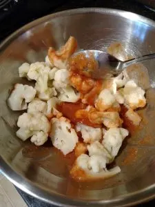 mixing cauliflower in bowl