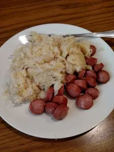 sauerkraut and hot dog on plate.