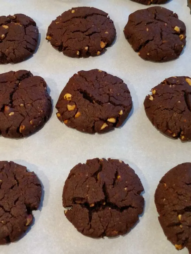 chocolate cookies cooling on parchment paper