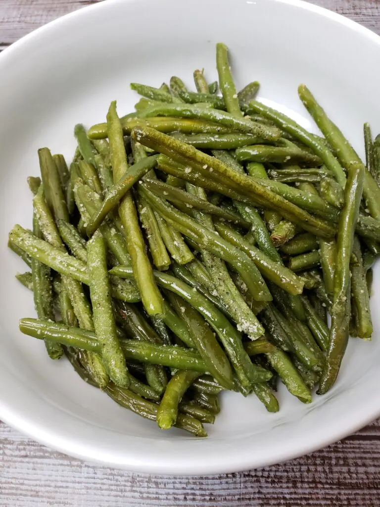 roasted parmesan green beans on a white plate