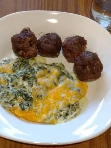 3 Ingredient Keto Crock Pot Meatballs and Creamy spinach cheese bake on white plate