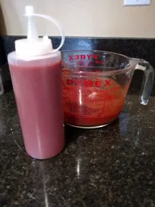 ketchup in serving container next to mixing container