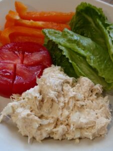 chicken salad with tomato, lettuce and orange bell pepper