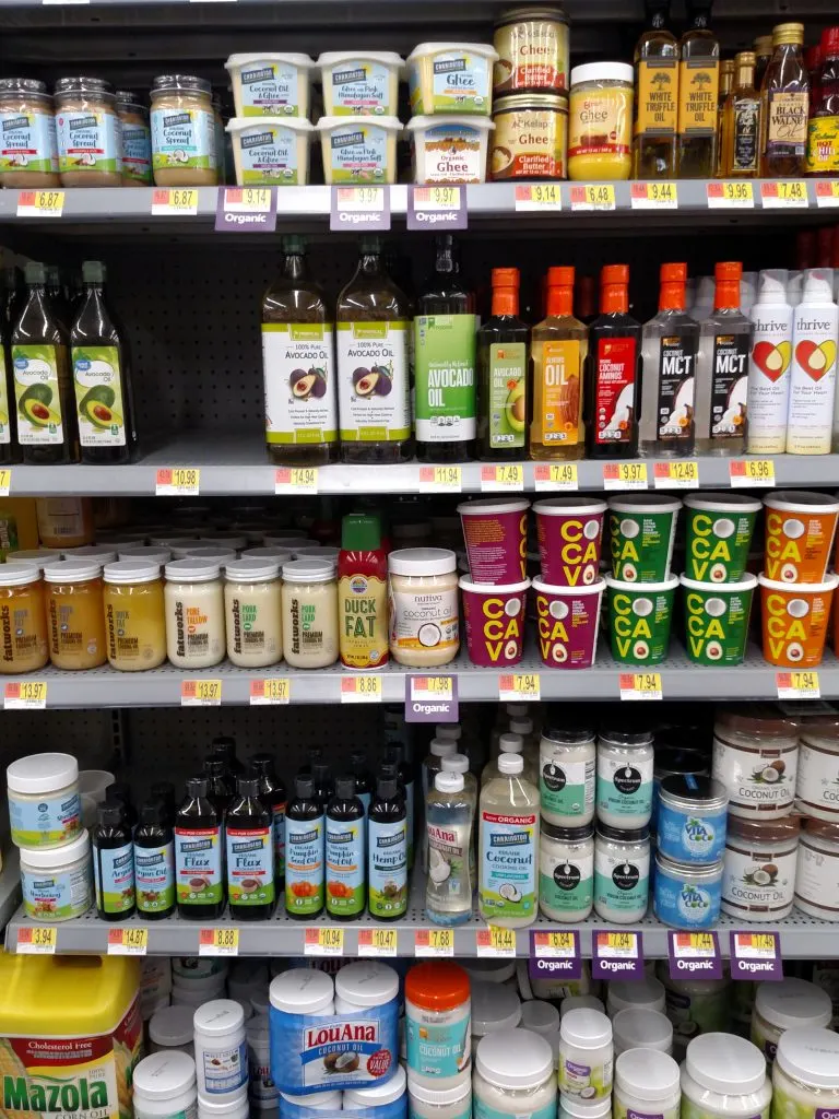 ghee, coconut and olive oil on store shelves