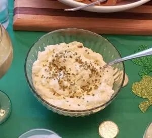 keto mashed cauliflower in glass bowl with chives on top