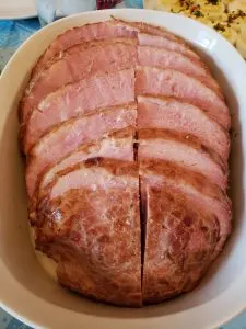 sliced ham in white serving dish