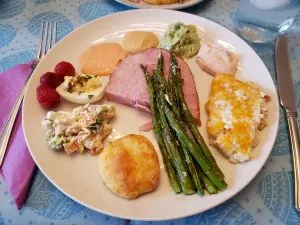 Easter dinner plate; ham, deviled eggs, asparagus, bun, etc.