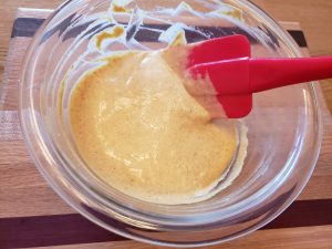 stirring Keto Spicy Sweet Mustard together in a bowl